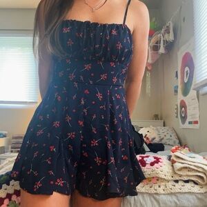 Francesca’s navy blue romper with red and white flowers details